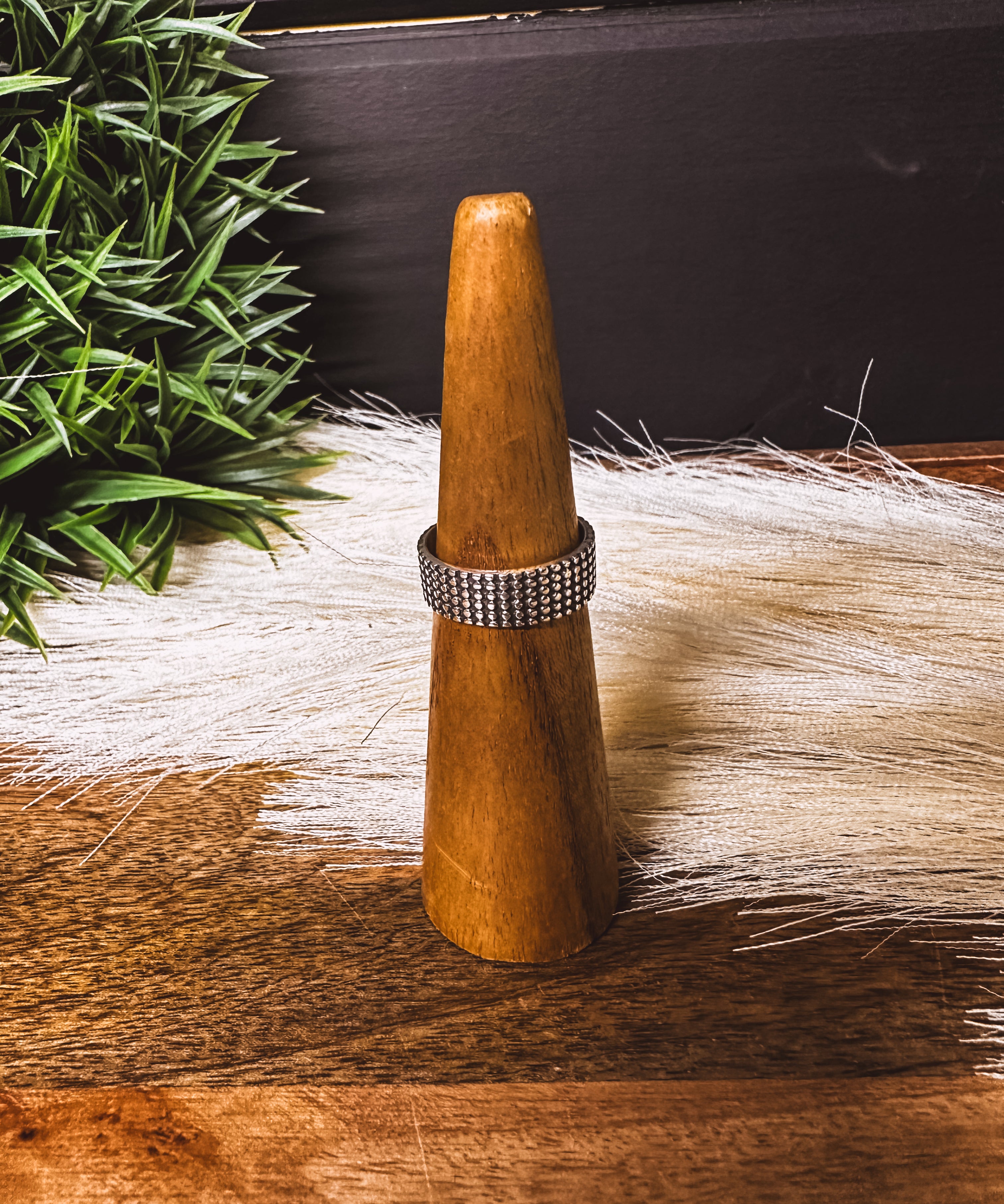 Wide band sterling silver ring with a textured finish.