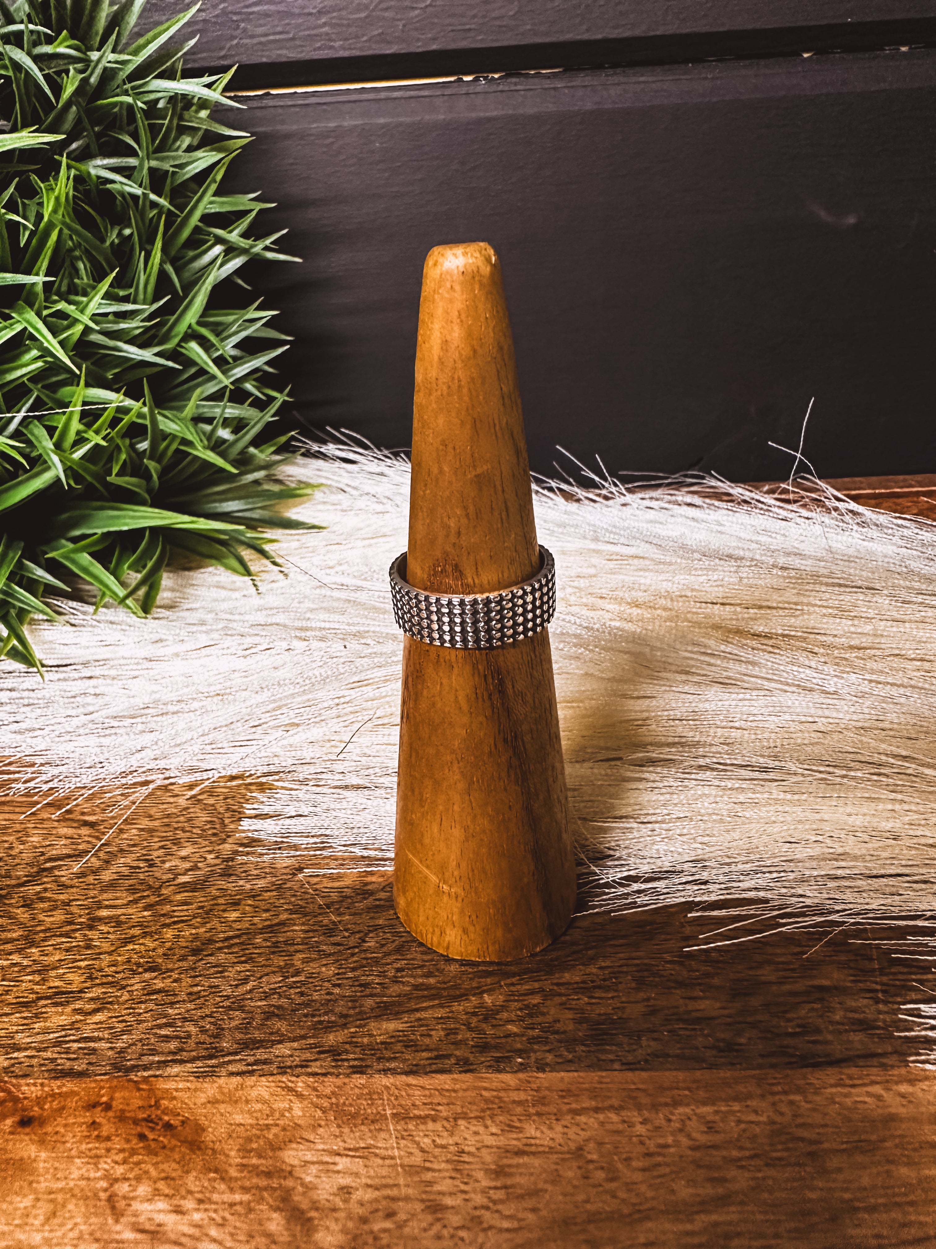 Wide band sterling silver ring with a textured finish.