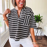 Black and white striped boxy cut Henley style knit top with 4 wooden buttons at the V neck, front pocket, short sleeves and shorter U shaped hem.