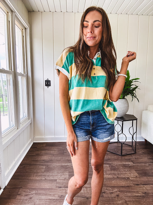 Oversized butter yellow and washed green wide striped Rugby style top with white collar and 1/4 metal button placket and cuffs.