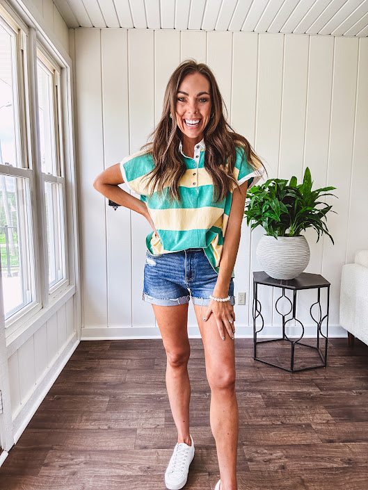Oversized butter yellow and washed green wide striped Rugby style top with white collar and 1/4 metal button placket and cuffs.