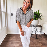 Lightweight black and white gingham dolman style top with mock neck, black and white striped V neck and elastic short sleeves.
