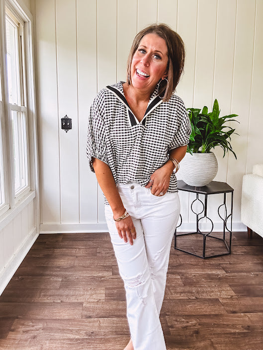 Lightweight black and white gingham dolman style top with mock neck, black and white striped V neck and elastic short sleeves.
