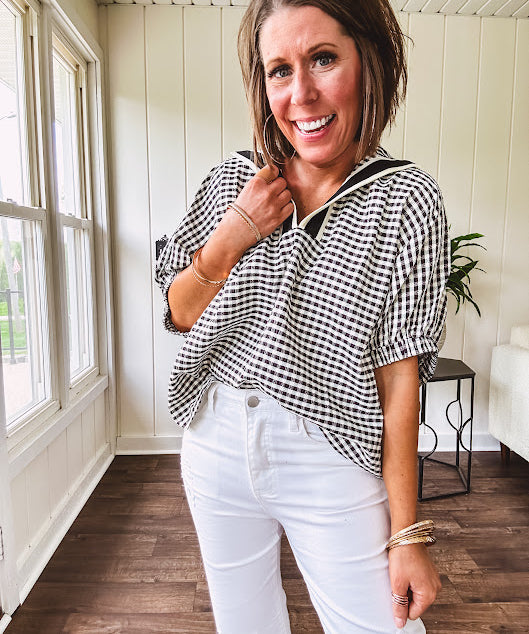 Lightweight black and white gingham dolman style top with mock neck, black and white striped V neck and elastic short sleeves.