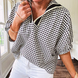 Lightweight black and white gingham dolman style top with mock neck, black and white striped V neck and elastic short sleeves.