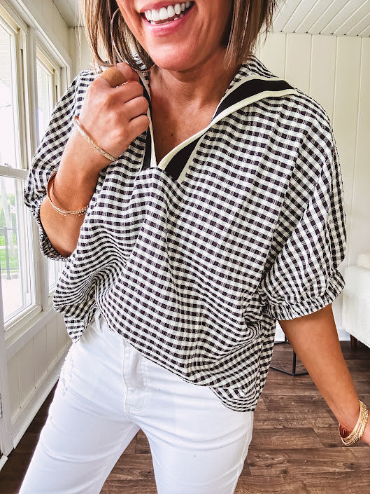 Lightweight black and white gingham dolman style top with mock neck, black and white striped V neck and elastic short sleeves.