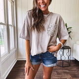 100% cotton faded tee with a crochet front pocket, split hem and oversized fit.
