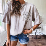 100% cotton faded tee with a crochet front pocket, split hem and oversized fit.