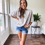 100% cotton faded tee with a crochet front pocket, split hem and oversized fit.