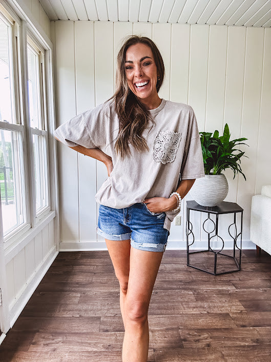 100% cotton faded tee with a crochet front pocket, split hem and oversized fit.