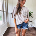 100% cotton faded tee with a crochet front pocket, split hem and oversized fit.