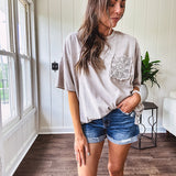 100% cotton faded tee with a crochet front pocket, split hem and oversized fit.