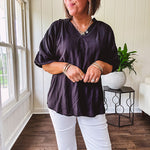 Lightweight, flowy V neck blouse with mock neck and puff short sleeves.