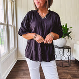Lightweight, flowy V neck blouse with mock neck and puff short sleeves.