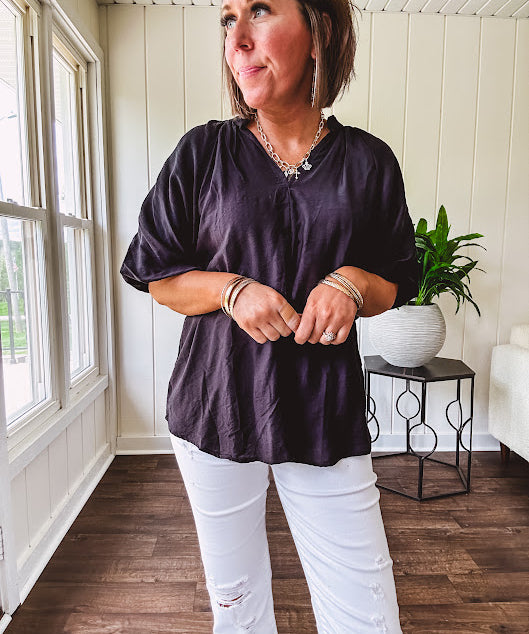 Lightweight, flowy V neck blouse with mock neck and puff short sleeves.