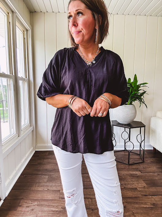 Lightweight, flowy V neck blouse with mock neck and puff short sleeves.