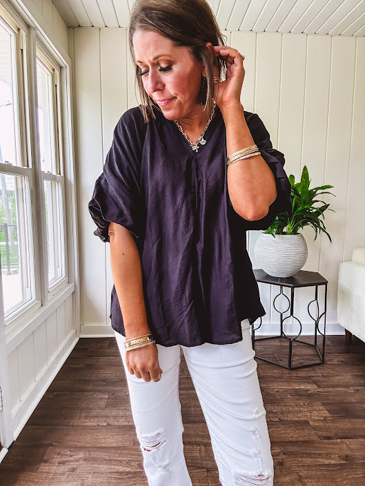 Lightweight, flowy V neck blouse with mock neck and puff short sleeves.