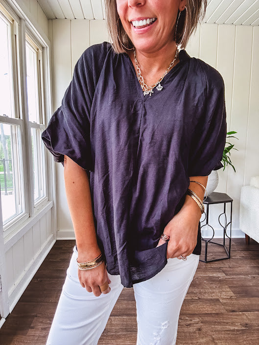 Lightweight, flowy V neck blouse with mock neck and puff short sleeves.