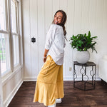 Thin, lightweight long sleeved button down blouse featuring white and blue or olive stripes adorned with small pastel floral embroidery throughout.