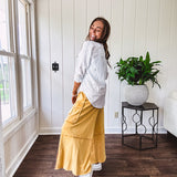 Thin, lightweight long sleeved button down blouse featuring white and blue or olive stripes adorned with small pastel floral embroidery throughout.