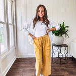 Thin, lightweight long sleeved button down blouse featuring white and blue or olive stripes adorned with small pastel floral embroidery throughout.