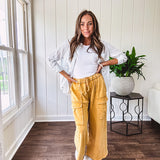 Thin, lightweight long sleeved button down blouse featuring white and blue or olive stripes adorned with small pastel floral embroidery throughout.