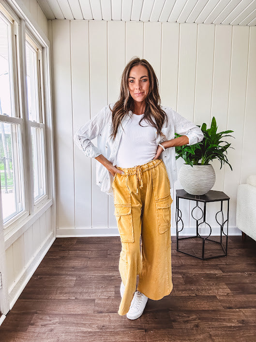 Thin, lightweight long sleeved button down blouse featuring white and blue or olive stripes adorned with small pastel floral embroidery throughout.