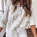Thin, lightweight long sleeved button down blouse featuring white and blue or olive stripes adorned with small pastel floral embroidery throughout.
