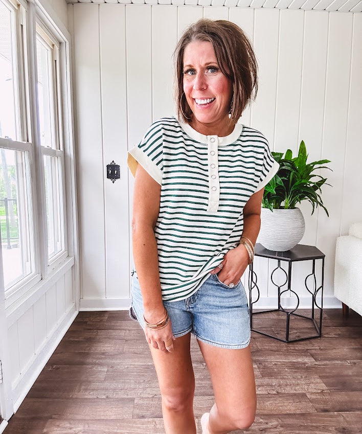 Cream and hunter green striped Henley tee shirt with 5 silver snap buttons on the front and U shaped hem.