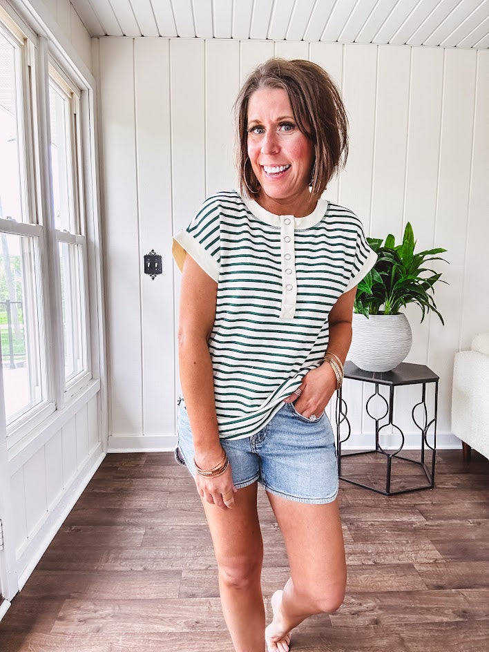 Cream and hunter green striped Henley tee shirt with 5 silver snap buttons on the front and U shaped hem.