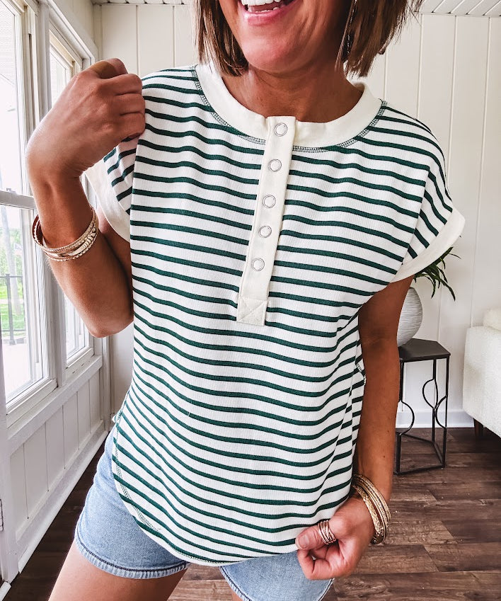 Cream and hunter green striped Henley tee shirt with 5 silver snap buttons on the front and U shaped hem.