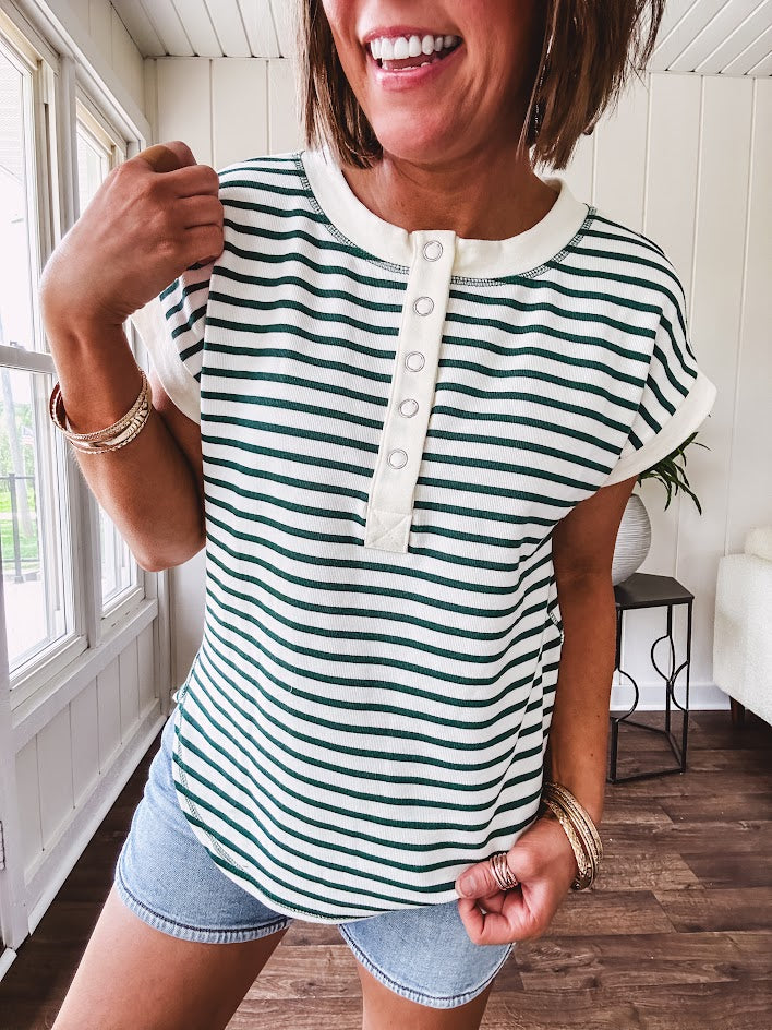 Cream and hunter green striped Henley tee shirt with 5 silver snap buttons on the front and U shaped hem.