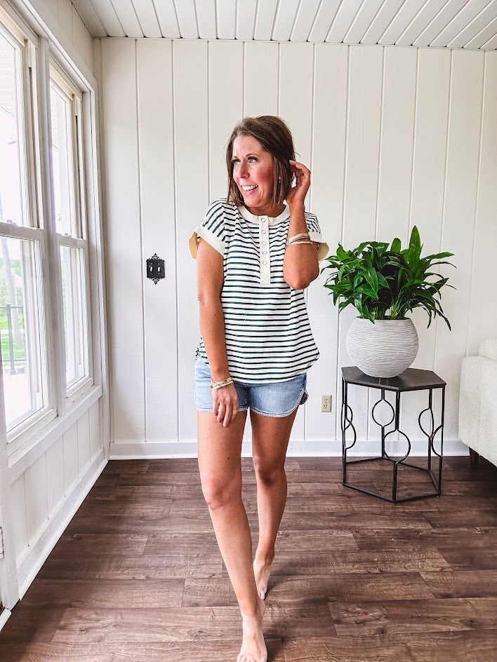 Cream and hunter green striped Henley tee shirt with 5 silver snap buttons on the front and U shaped hem.