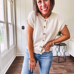 Soft, woven sweater vest with cap sleeves and faux wooden buttons down the front available in cream, sage and blush.