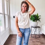 Soft, woven sweater vest with cap sleeves and faux wooden buttons down the front available in cream, sage and blush.