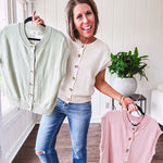 Soft, woven sweater vest with cap sleeves and faux wooden buttons down the front available in cream, sage and blush.
