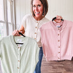 Soft, woven sweater vest with cap sleeves and faux wooden buttons down the front available in cream, sage and blush.