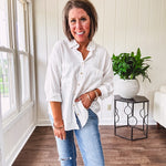 White, nearly sheer long sleeved button down with two front pockets, faux wooden buttons down the front and an oversized fit.