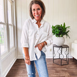 White, nearly sheer long sleeved button down with two front pockets, faux wooden buttons down the front and an oversized fit.