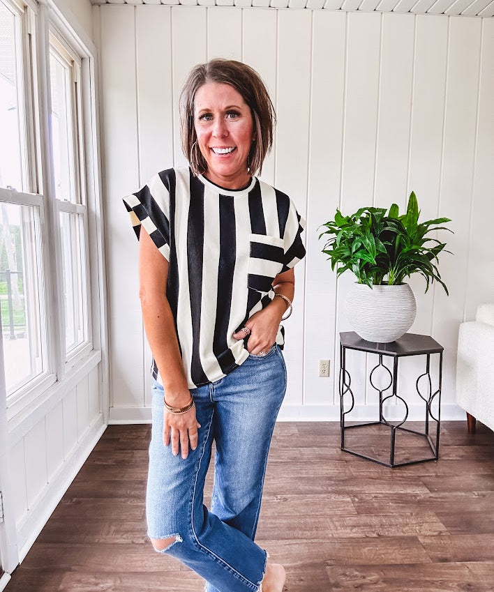 Soft, lightweight black and ivory color block striped tee with cuffed sleeves and front pocket.