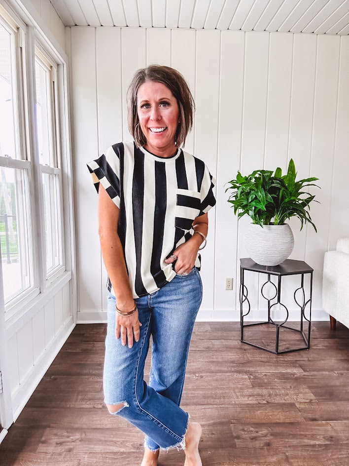 Soft, lightweight black and ivory color block striped tee with cuffed sleeves and front pocket.