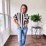 Soft, lightweight black and ivory color block striped tee with cuffed sleeves and front pocket.