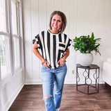 Soft, lightweight black and ivory color block striped tee with cuffed sleeves and front pocket.