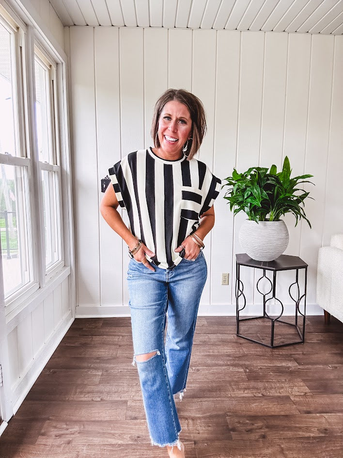 Soft, lightweight black and ivory color block striped tee with cuffed sleeves and front pocket.
