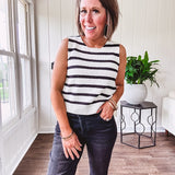 Soft black and white striped knit sweater vest with round neck and black bow ties at the back.