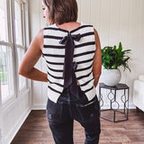 Soft black and white striped knit sweater vest with round neck and black bow ties at the back.