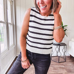 Soft black and white striped knit sweater vest with round neck and black bow ties at the back.