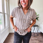 Soft, lightweight mocha and black striped collared shirt with V neck and 3 faux wooden buttons on the front, front pocket and cuffed sleeves.