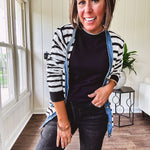 Soft black round neck sweater tank with faux grey layering trim at the neck and hem.