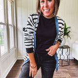 Soft black round neck sweater tank with faux grey layering trim at the neck and hem.